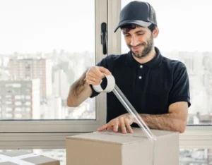 Office movers packing and handling office equipment during relocation